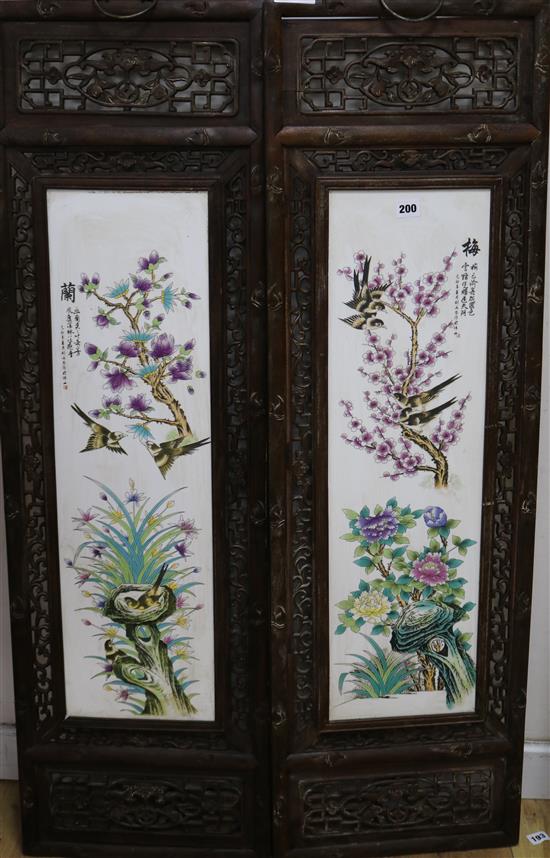 A pair of Chinese porcelain panels, in carved wood frames panels 75 x 21cm